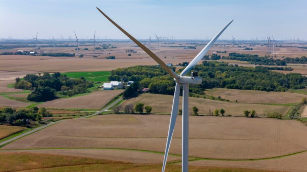 Working turbines spin in the wind over farmland in Henry County on Oct. 2, 2024. (Brian Cassella/Chicago Tribune)