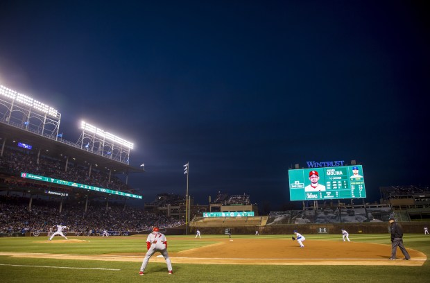 Cubs starting pitcher Jon Lester delivers to the Cardinals in front of the left-field new video board on April 5, 2015, at Wrigley Field. (Brian Cassella/Chicago Tribune)