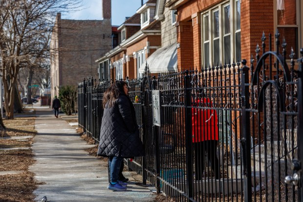 State Sen. Graciela Guzmán, left, talks with a woman outside a home where a man was detained by federal immigration officers earlier in the day on the 4300 block of West Dickens Avenue in the Hermosa neighborhood on Jan. 26, 2025. (Armando L. Sanchez/Chicago Tribune)