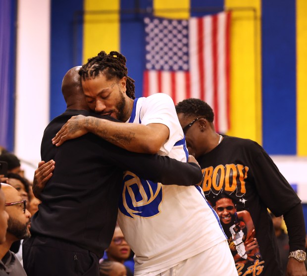 Derrick Rose hugs a friend while playing in an alumni game as he is honored at Simeon Career Academy on Friday, Jan. 3, 2025, in Chicago. The Simeon graduate and former Chicago Bulls superstar is being honored at the United Center on Saturday night during a Bulls vs. New York Knicks game. (Chris Sweda/Chicago Tribune)