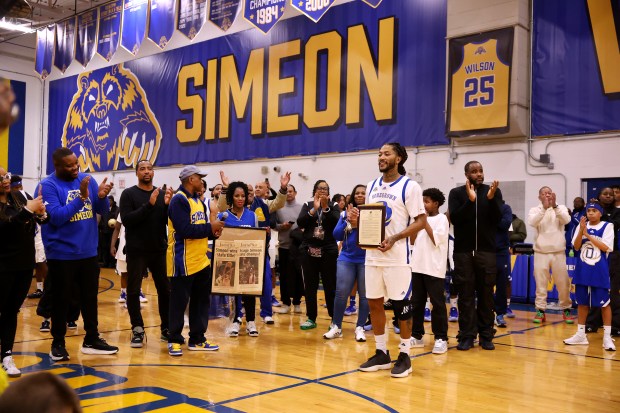 Derrick Rose holds a plaque given to him in his honor at Simeon Career Academy in Chicago on Friday, Jan. 3, 2025. The Simeon graduate and former Chicago Bulls superstar is being honored at the United Center on Saturday night during a Bulls vs. New York Knicks game. (Chris Sweda/Chicago Tribune)