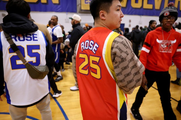 Fans of Derrick Rose stand on the basketball court at Simeon Career Academy in Chicago after a game featuring Rose and a ceremony honoring the former Simeon star on Friday, Jan. 3, 2025. Rose, the former superstar for the Chicago Bulls, is being honored at the United Center on Saturday night during a Bulls vs. New York Knicks game. (Chris Sweda/Chicago Tribune)