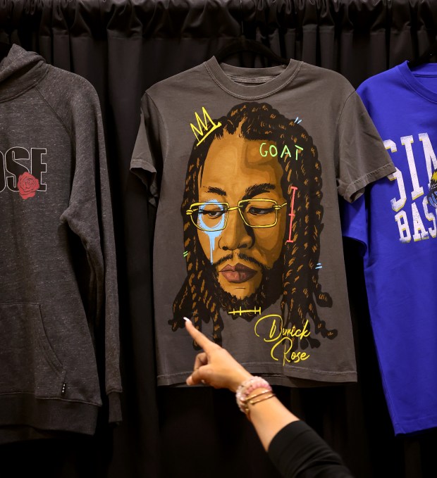 A woman points at a Derrick Rose themed t-shirt for sale during a game featuring Rose at Simeon Career Academy in Chicago on Friday, Jan. 3, 2025. Rose, the Simeon graduate and former Chicago Bulls superstar, is being honored at the United Center on Saturday night during a Bulls vs. New York Knicks game. (Chris Sweda/Chicago Tribune)