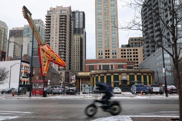 A cyclist on Clark Street rides past the Hard Rock Cafe on Jan. 22, 2025. The restaurant in River North is set to close March 29. (Eileen T. Meslar/Chicago Tribune)