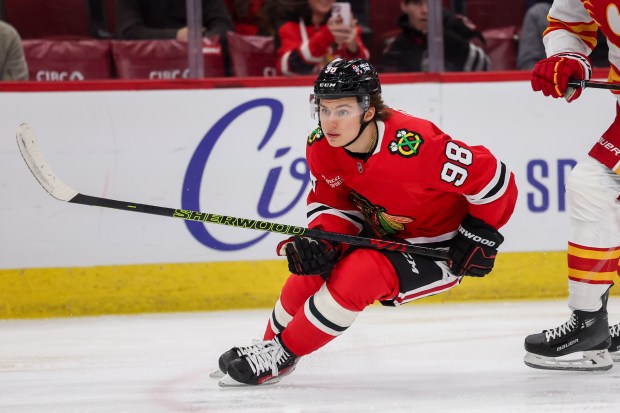 Chicago Blackhawks center Connor Bedard (98) skates past Calgary Flames defenseman Kevin Bahl (7) during the first period at the United Center Monday Jan. 13, 2025, in Chicago. (Armando L. Sanchez/Chicago Tribune)