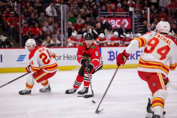 Chicago Blackhawks center Ryan Donato (8) reaches for the puck during the first period against the Calgary Flames at the United Center Monday Jan. 13, 2025, in Chicago. (Armando L. Sanchez/Chicago Tribune)