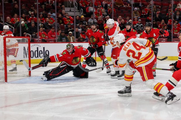 Calgary Flames defenseman Jake Bean (24) scores a goal past Chicago Blackhawks goaltender Petr Mrazek (34) during the second period at the United Center Monday Jan. 13, 2025, in Chicago. (Armando L. Sanchez/Chicago Tribune)