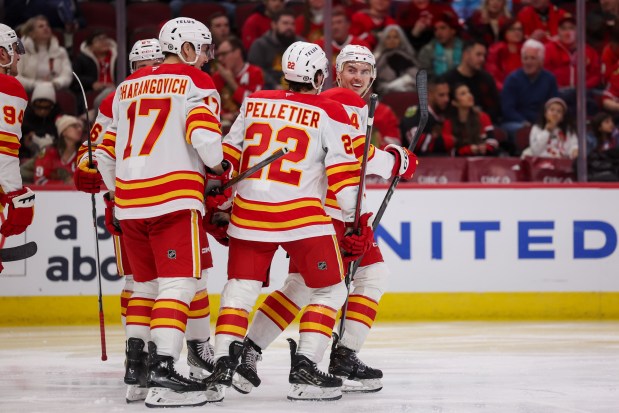 Calgary Flames defenseman Jake Bean (24) looks back at Calgary Flames left wing Jakob Pelletier (22) after Bean scored a goal during the second period against the Chicago Blackhawks at the United Center Monday Jan. 13, 2025, in Chicago. (Armando L. Sanchez/Chicago Tribune)