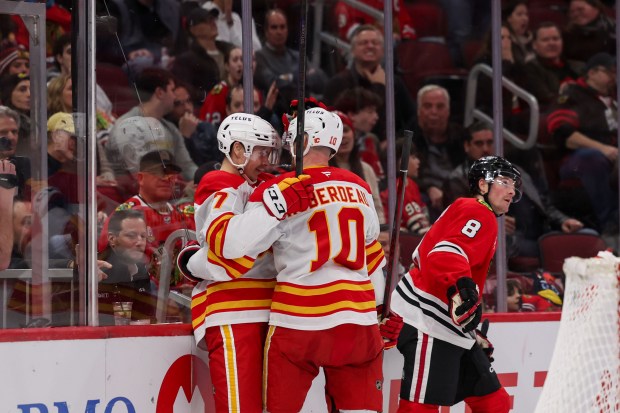 Calgary Flames center Jonathan Huberdeau (10) celebrates with Calgary Flames center Yegor Sharangovich (17) after Sharangovich scored a goal during the second period against the Chicago Blackhawks at the United Center Monday Jan. 13, 2025, in Chicago. (Armando L. Sanchez/Chicago Tribune)