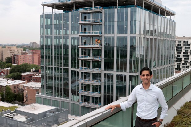 Samir Mayekar, president of the University of Chicago Polsky Center for Entrepreneurship and Innovation, on a balcony overlooking the construction of Hyde Park Labs, Aug. 1, 2024. (Antonio Perez/Chicago Tribune)