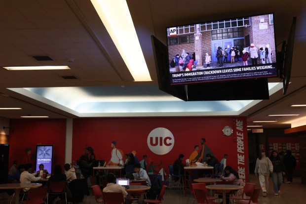 An Associated Press headline about the Trump administration's newest immigration policies is displayed on information screens at UIC Student Center East on Jan. 22, 2025. UIC faculty and staff are being instructed to contact campus police if federal immigration officials attempt to enter classrooms and student-populated buildings to inquire about citizenship or immigration status. (John J. Kim/Chicago Tribune)