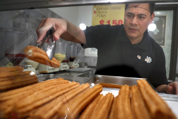 Edwin Molina, co-owner of Don Churro in Chicago's Pilsen neighborhood, discusses a decrease in his sales, possibly due to fear of deportation among the street vendors who buy and resell his churros, Jan. 24, 2025. (Antonio Perez/Chicago Tribune)