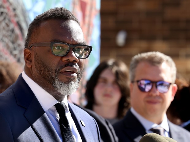 Chicago Public Schools CEO Pedro Martinez looks on as Mayor Brandon Johnson speaks during a ribbon cutting ceremony outside Uplift Community High School on Sept. 3, 2024. (Antonio Perez/Chicago Tribune)