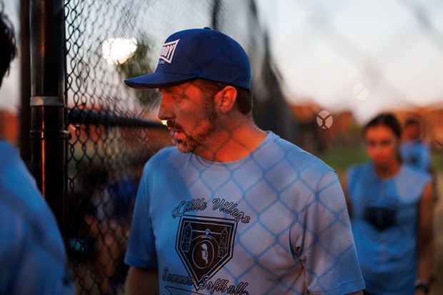 Matt DeMatteo, executive director and pastor at New Life Centers, a nonprofit organization helping migrants in collaboration with the city and state, plays softball in La Villita Park Aug. 29, 2024. (Armando L. Sanchez/Chicago Tribune)