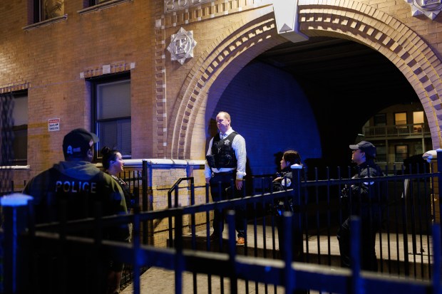 Chicago police officers work at the scene where a man was shot in the back and neck inside an apartment building in the 6100 block of South King Drive in Chicago's Washington Park neighborhood on Nov. 19, 2024. (Armando L. Sanchez/Chicago Tribune)