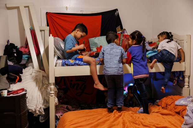 From left, Manuel Farfan, 9, Alejandro Yovera, 4, Dariandy Araquez, 6, and Milagro Sofia Sanchez, 4, play in a bedroom in Yorgelis Rangel's home on Jan. 8, 2025. (Armando L. Sanchez/Chicago Tribune)