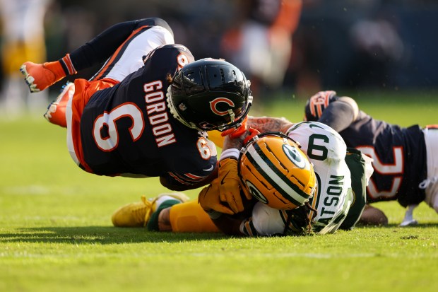 Packers wide receiver Christian Watson (9) makes a catch for a first down past Chicago Bears cornerback Kyler Gordon (6) during the fourth quarter. (Armando L. Sanchez/Chicago Tribune)