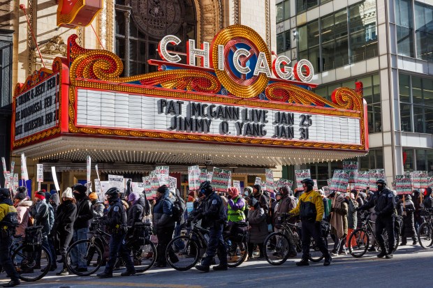 Anti-Trump activists march in the Loop past the Chicago Theatre on the day of President Donald Trump's inauguration, Jan. 20, 2025. (Armando L. Sanchez/Chicago Tribune)