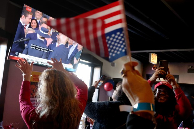 Dozens of Donald Trump supporters celebrate at an inauguration watch party at Danny's Pizza Place in Chicago, Jan. 20, 2025. (Antonio Perez/Chicago Tribune)