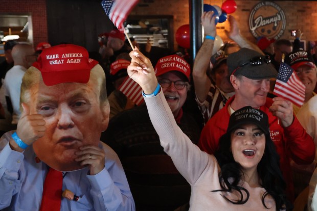 President Donald Trump supporters celebrate the inauguration while watching TVs at Danny's Pizza Place in Chicago, Jan. 20, 2025. (Antonio Perez/Chicago Tribune)