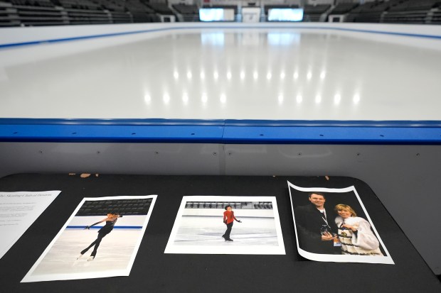 Photographs of aircraft crash victims from The Skating Club of Boston are displayed rinkside on Thursday, Jan. 30, 2025, in Norwood, Mass. From left are skater Jinna Han, skater Spencer Lane and coaches Vadim Naumov and Evgenia Shishkova. (AP Photo/Charles Krupa)