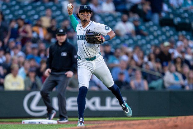 Mariners third baseman Josh Rojas throws to first base after fielding a grounder against the Angels on July 23, 2024, in Seattle. (Stephen Brashear/AP)