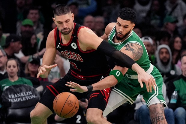 Celtics forward Jayson Tatum, right, tries to steal the ball from Bulls center Nikola Vučević during the second half on Jan. 29, 2025, in Boston. (Charles Krupa/AP)