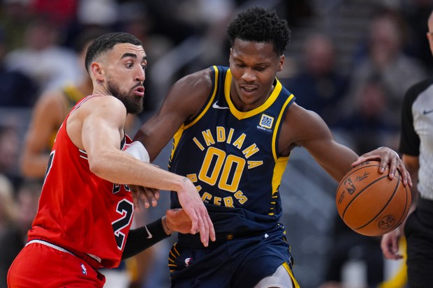 Chicago Bulls guard Chris Duarte (27) defends Indiana Pacers guard Bennedict Mathurin (00) during the second half of an NBA basketball game in Indianapolis, Wednesday, Jan. 8, 2025. (AP Photo/Michael Conroy)