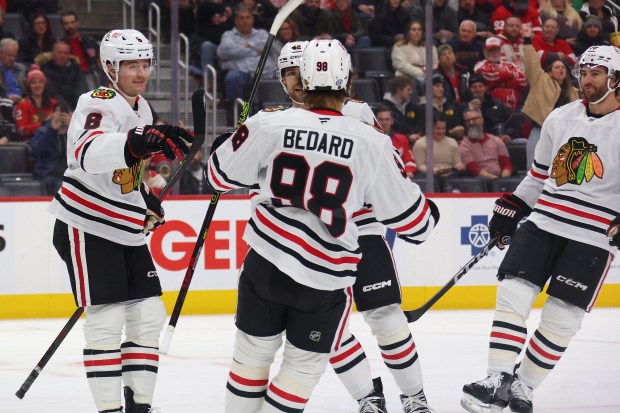 Ryan Donato #8 of the Chicago Blackhawks celebrates his first period goal with Connor Bedard #98, Nolan Allan #42 and TJ Brodie #78 at Little Caesars Arena on Jan. 10, 2025 in Detroit, Michigan. (Photo by Gregory Shamus/Getty Images)