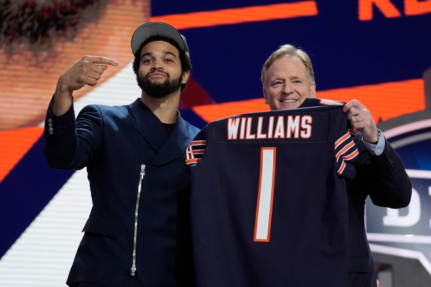 Southern California quarterback Caleb Williams celebrates with NFL commissioner Roger Goodell after being chosen by the Chicago Bears with the first overall pick during the first round of the NFL football draft, Thursday, April 25, 2024, in Detroit. (AP Photo/Jeff Roberson)