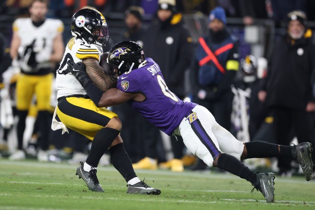 Ravens linebacker Roquan Smith, right, tackles the Steelers' Jaylen Warren during a wild-card playoff game on Jan. 11, 2025 in Baltimore. (Al Bello/Getty Images)