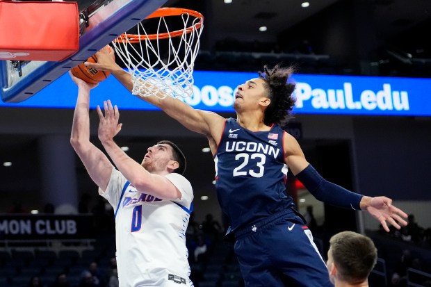 UConn forward Jayden Ross, right, blocks a shot by DePaul forward Troy D'Amico during the second half of an NCAA college basketball game in Chicago, Wednesday, Jan. 1, 2025. (AP Photo/Nam Y. Huh)