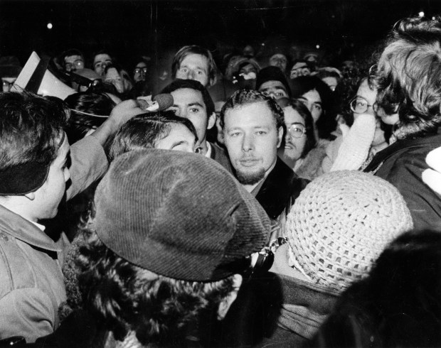 Jose "Cha Cha" Jimenez, center, the leader of the Young Lords organization, gets an enthusiastic reception as he turns himself in to the Chicago police at the Town Hall district on Dec. 6, 1972. (Ovie Carter/Chicago Tribune)