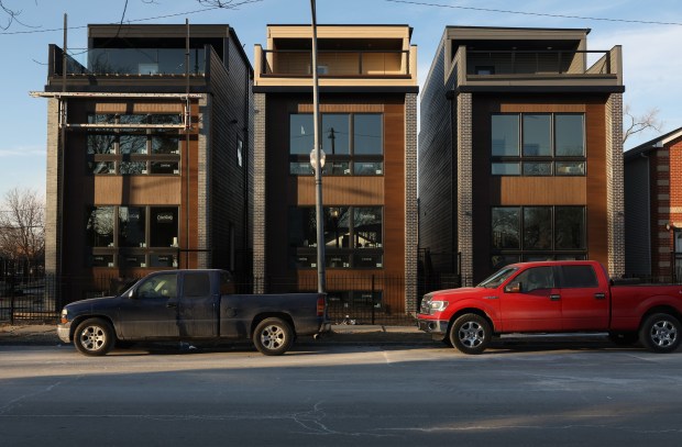 A trio of newly-constructed single family homes line the 4200 block of West 5th Avenue Thursday, Jan. 9, 2025, in Chicago. The homes were designed by former Collins Academy High School teacher Lawon Williams and architect Bryan Hudson with the help of several Collins graduates. (John J. Kim/Chicago Tribune)