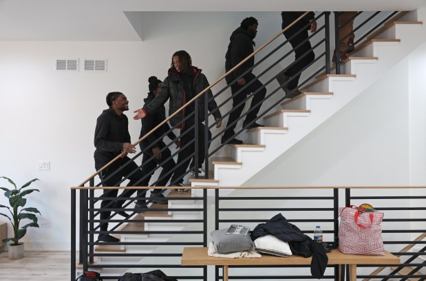 Former Collins Academy High School students tour a house they helped design in the 4200 block of West 5th Avenue on Jan. 9, 2025. (John J. Kim/Chicago Tribune)