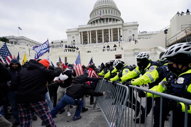 Insurrectionists loyal to President Donald Trump try to break through a police barrier, Jan. 6, 2021, at the Capitol in Washington. (AP Photo/Julio Cortez, File)