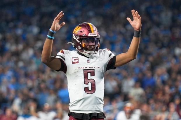 Commanders quarterback Jayden Daniels celebrates a touchdown against the Lions during an NFC divisional-round playoff game on Jan. 18, 2025, in Detroit. (Seth Wenig/AP)