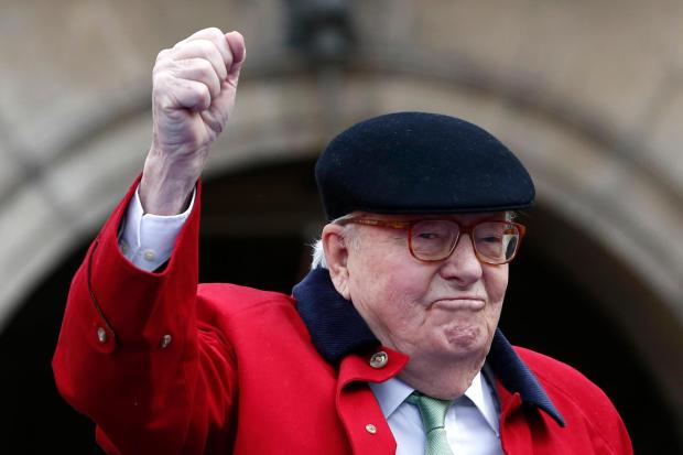 FILE - Former far-right National Front party leader Jean-Marie Le Pen clenches his fist at the statue of Joan of Arc, Monday May 1, 2017, in Paris. (AP Photo/Kamil Zihnioglu, File)