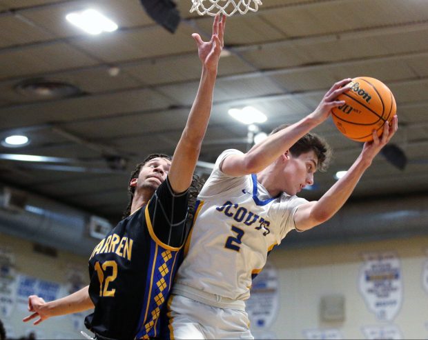 Lake Forest's Grant Mordini (2), winning a rebound against Warren's Zach Ausburn (12), during the game on Friday, Jan. 24, 2024, in Lake Forest. (Mark Ukena/for the Lake County News-Sun)