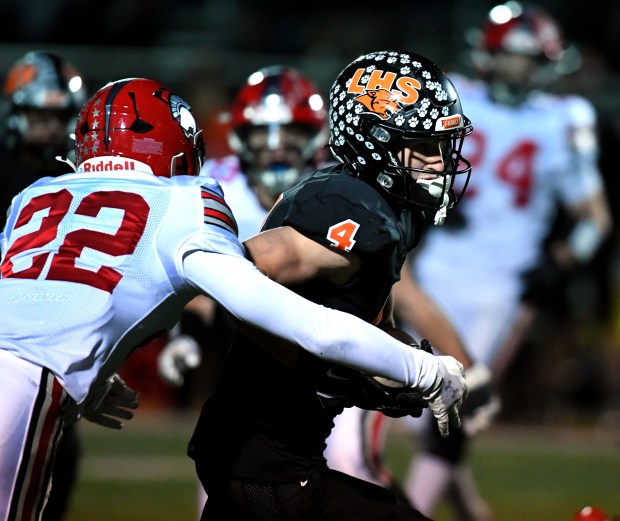 Deerfield's Jonah Belden (22) can't wrap up Libertyville's Blaise LaVista (4). Libertyville defeated Deerfield 43-10 in their game in the first round of the Class 6A playoffs in Libertyville on Friday, Nov. 1, 2024 (Rob Dicker / for the News-Sun)