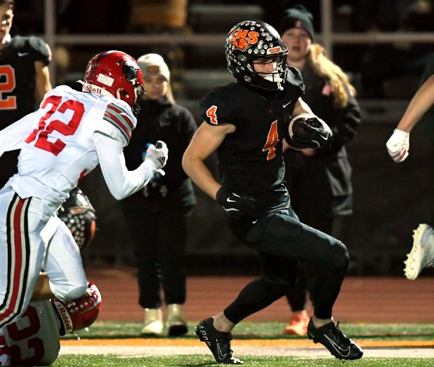 Libertyville's Blaise LaVista (4) heads to the end zone as Deerfield' Trey Pontikes (32) tries to catch up with him. Libertyville defeated Deerfield 43-10 in their game in the first round of the Class 6A playoffs in Libertyville on Friday, Nov. 1, 2024 (Rob Dicker / for the News-Sun)