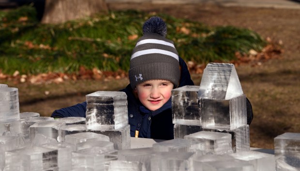 Playing with ice blocks on a table is Cameron Johann, 3, of Arlington Heights at Frosty Fest on Jan. 4, 2025 at Viking Park (4374 Old Grand Ave.) in Gurnee. (Karie Angell Luc/Lake County News-Sun)