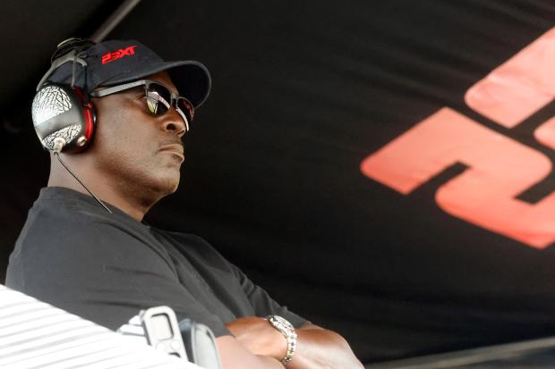 Michael Jordan, co-owner of 23XI Racing, sits in his pit box during a NASCAR Cup Series auto race at Talladega Superspeedway on Oct. 6, 2024, in Talladega, Ala. (AP Photo/ Butch Dill)