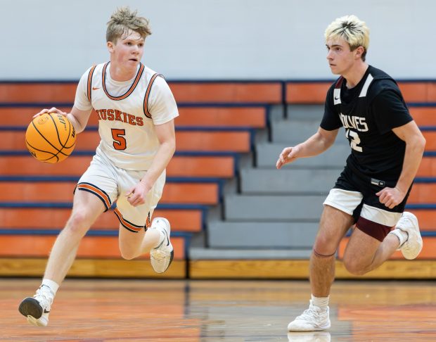 Naperville North's Max Steele (5) brings the ball down court against Prairie Ridge during a non-conference game in Naperville on Friday, Jan. 3, 2025. (Troy Stolt / for the Naperville Sun)