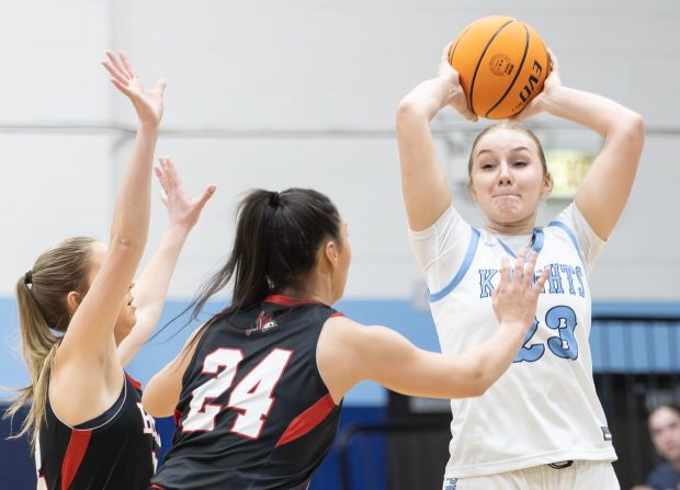 Prospect's Alli Linke (23) passes the ball against Benet during a game in the Coach Kipp Hoopsfest in La Grange Park on Saturday, Jan. 18, 2025. (Troy Stolt / for the Pioneer Press)