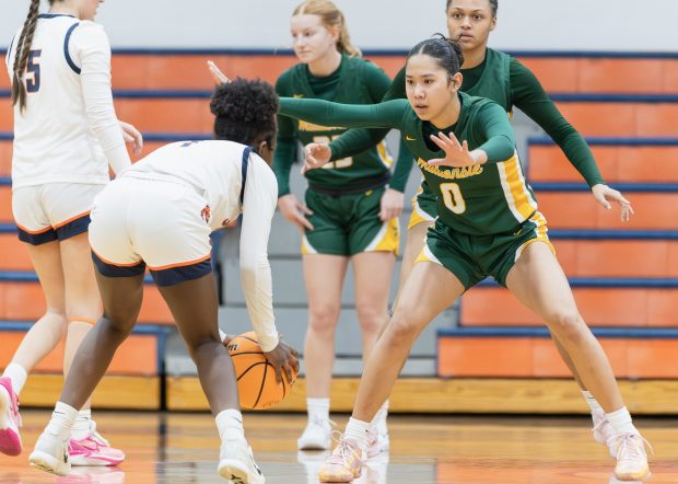 Waubonsie Valley's Maya Pereda (0) guards Naperville North's Natalie Frempong (1) during a DuPage Valley Conference game in Naperville on Thursday, Jan. 9, 2025. (Troy Stolt / for the Naperville Sun)