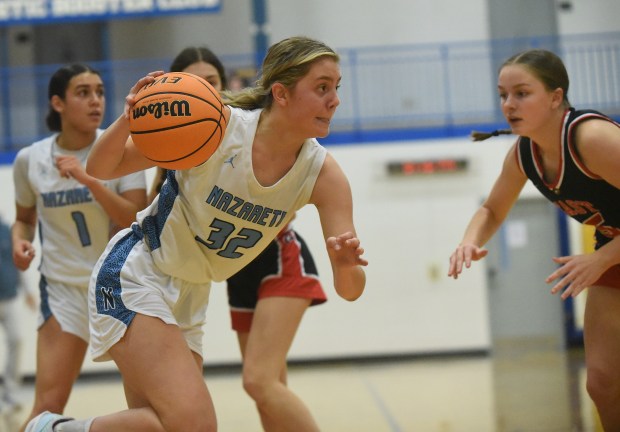 Nazareth's Stella Sakalas (32) drives to the basket against Glenbard East during the Sandburg Holiday Classic Thursday, Dec. 26, 2024 in Orland Park, IL. (Steve Johnston/for Pioneer Press)