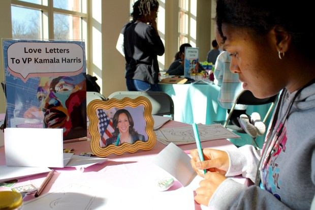 Here Addison Miller (12) of Beach Park writes a love letter to former Vice President, Kamala Harris, during the Fill a Heart 4 Kids Martin Luther King experience on Monday, Jan. 20 at The Gloria Dei Center, located in the Woodlands Academy of the Sacred Heart in Lake Forest. (Gina Grillo/ for the Pioneer Press)