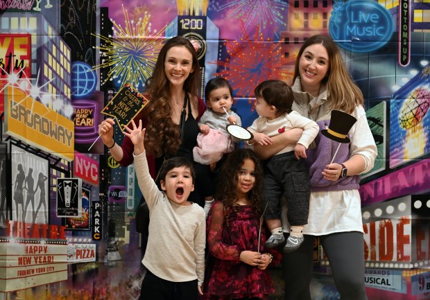 Top row, from left are childhood friends Stephanie Nandi of Lake Forest and Meaghan Jones of Deerfield, both of the Deerfield High School Class of 2007. From left, being held are Ellie Nandi, 1, and Teddy Jones, 11 months. Bottom row from left are Luke Nandi, 4, and Avery Jones, 4. Taken at Noon Year's Eve on Dec. 31, 2024 in Deerfield at Sachs Recreation Center. (Karie Angell Luc/Pioneer Press)