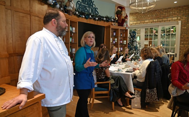 From left, TeaLula Executive Chef Jeff Scialabba of Park Ridge and Sheila Duda of Park Ridge, TeaLula owner, present the menu at the Park Ridge Chamber of Commerce's Holiday Tea Party at TeaLula in Park Ridge on Dec. 18, 2024. (Karie Angell Luc/Pioneer Press)